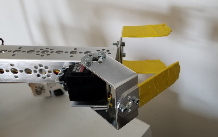 A robot claw mechanism where the metal claws are wrapped in electrical tape.